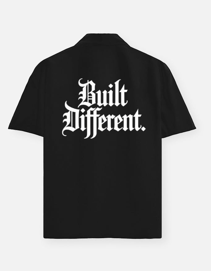 WYND black 100% cotton oversized shirt with half sleeves and white gothic text "Built Different" on the back.